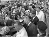 Crowd in rain gear gathered to hear John F. Kennedy speak outside Hotel Texas, 11/22/1963